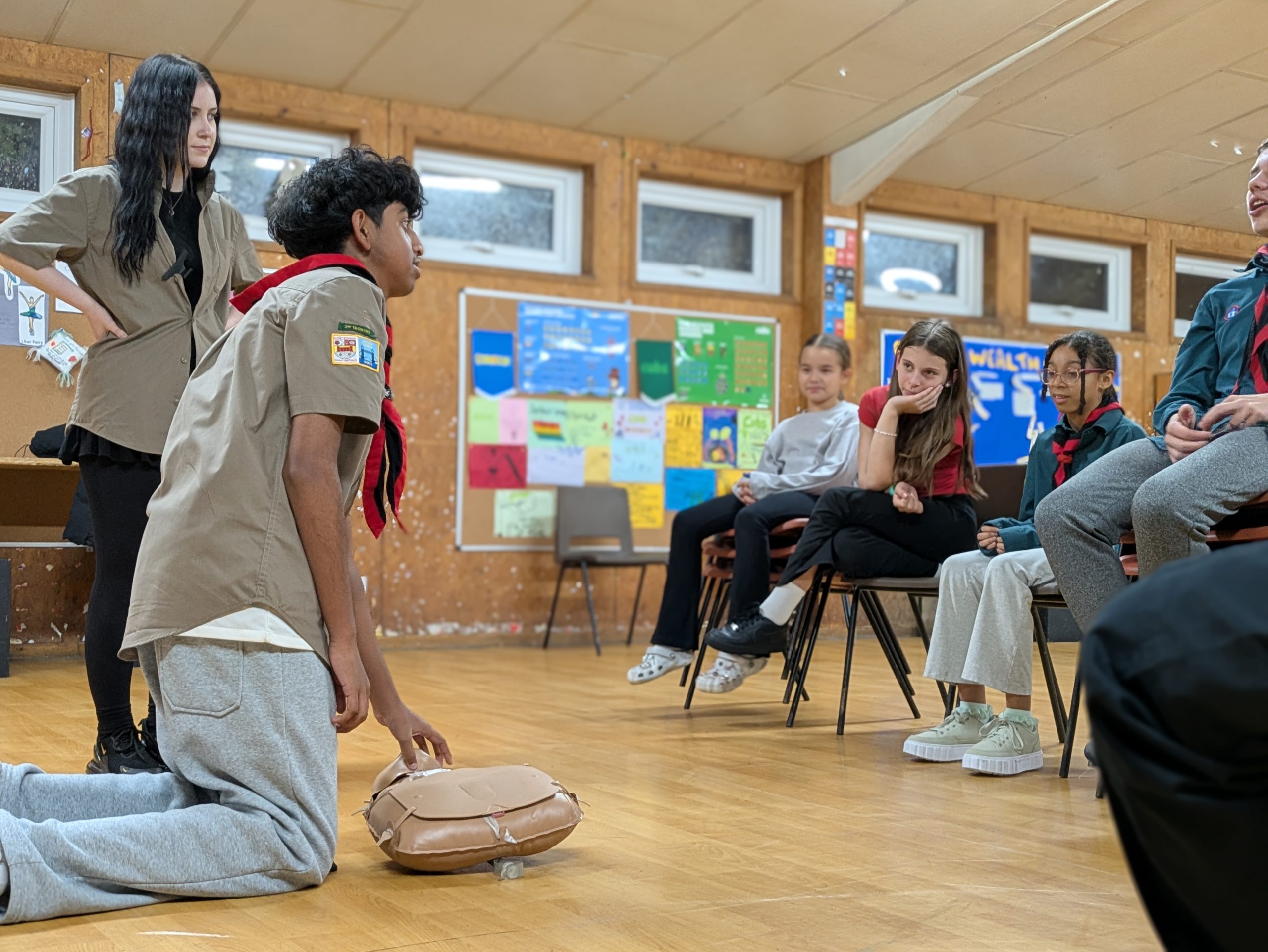 A group of Scouts learning CPR