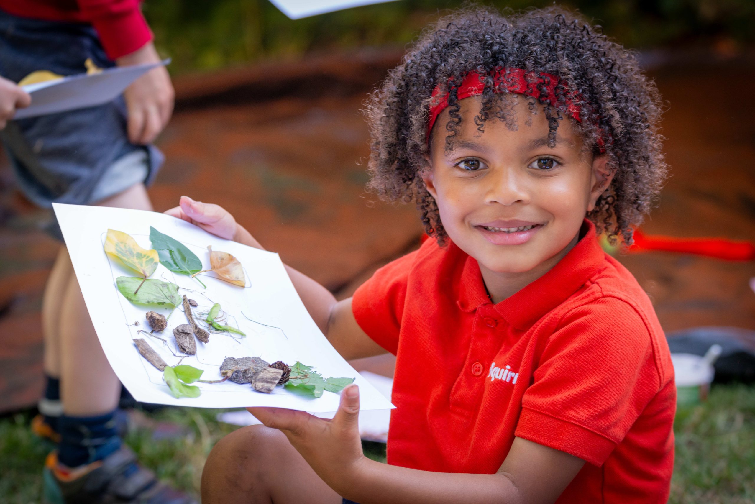 A Squirrel Scout making art with leaves