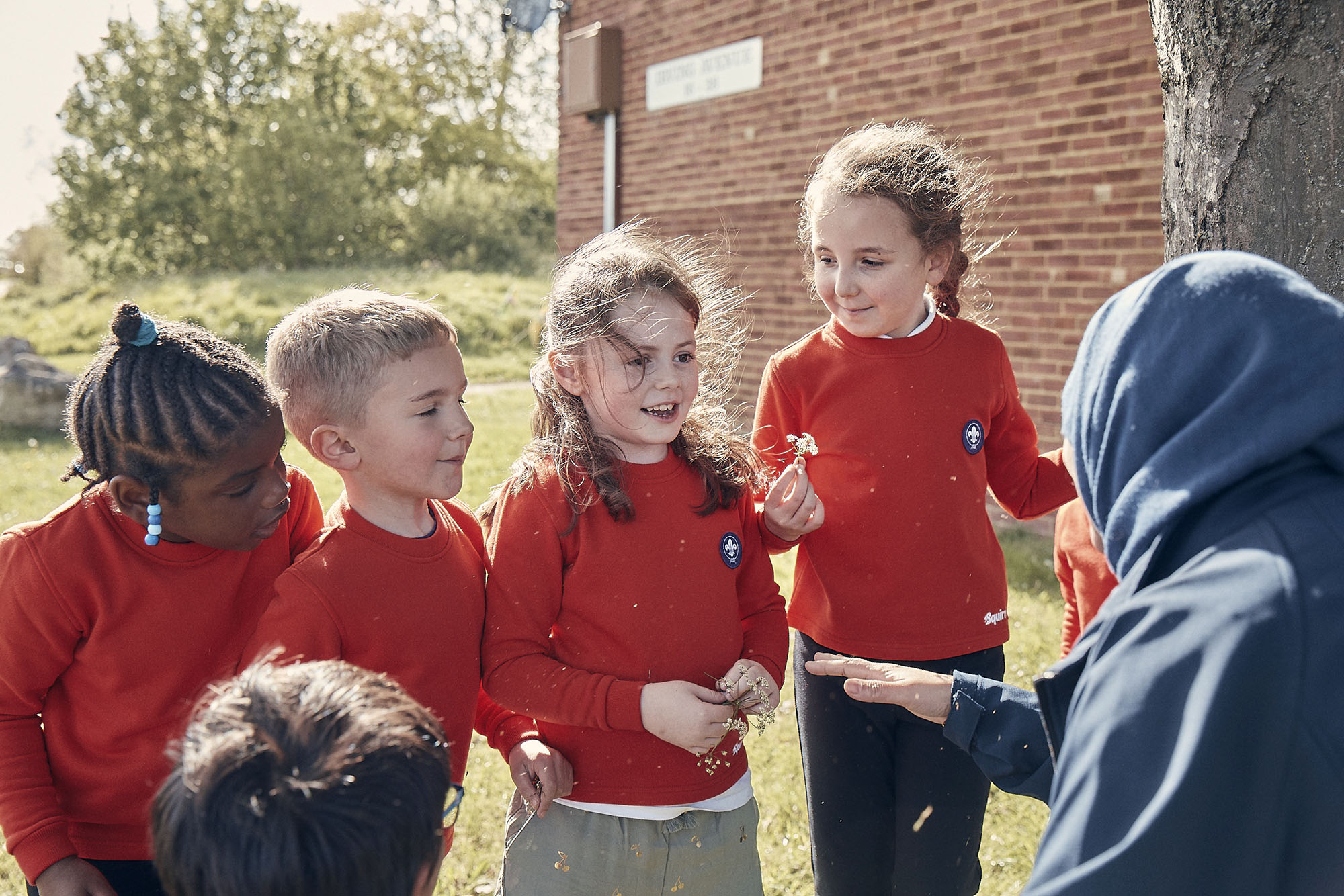 A group of Squirrel Scouts talking with a volunteer leader